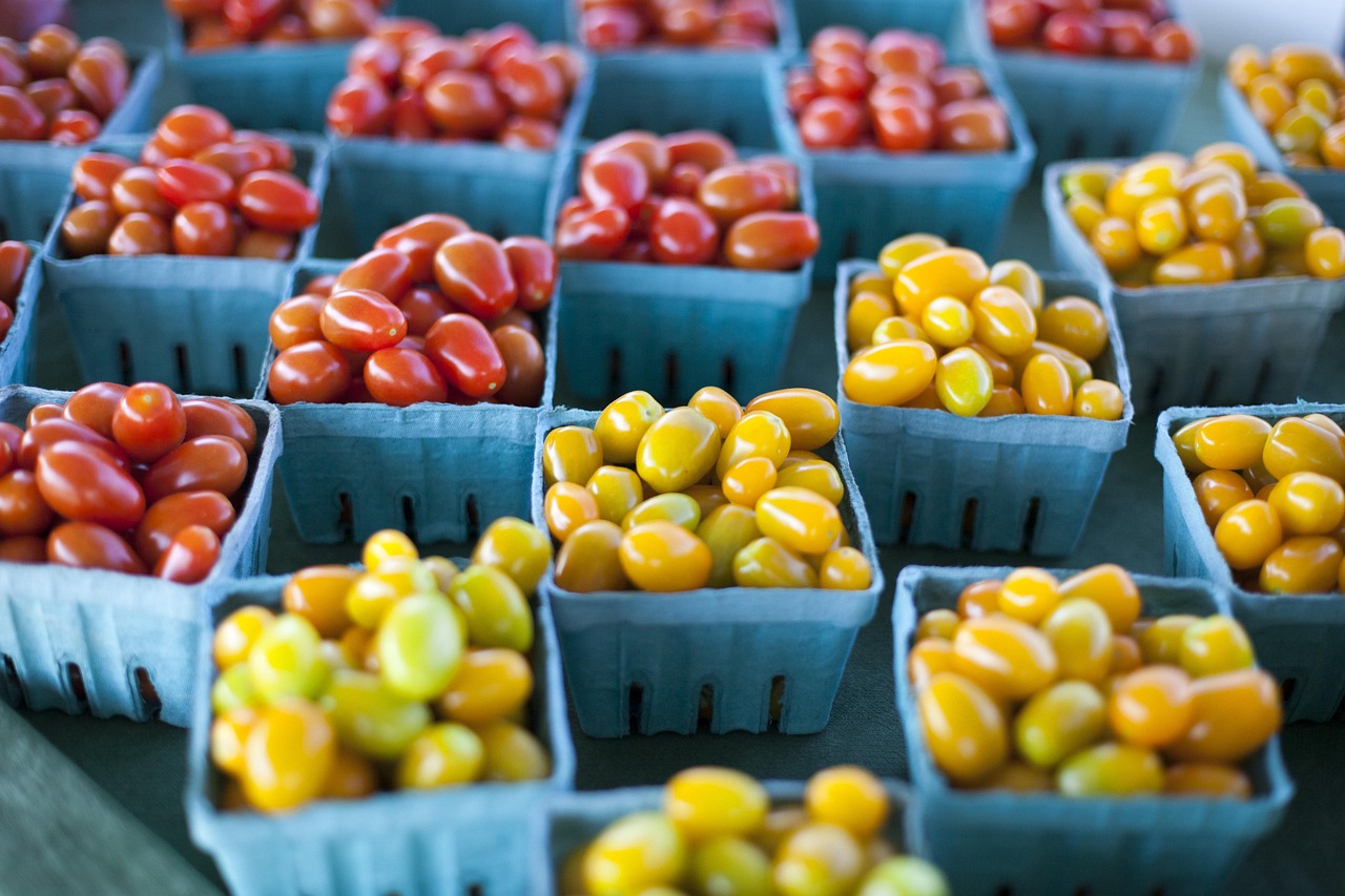 Baskets of ripe red tomatoes at a roadside stand